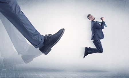Businessman big foot kicking small, young businessman who is flying