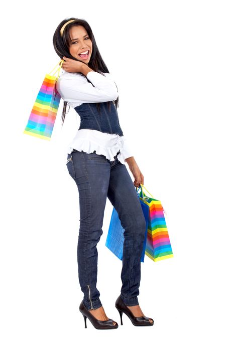 Casual woman walking with shopping bags isolated over a white background