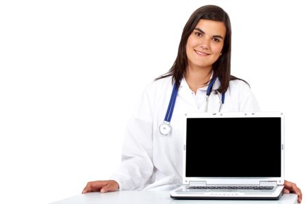 female doctor smiling while displaying a laptop computer isolated over a white background
