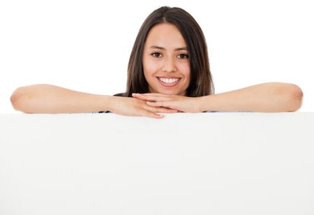 Happy woman leaning on a banner - isolated over a white background