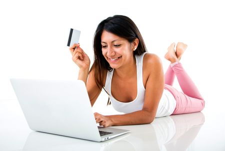 Woman online shopping on a laptop computer - isolated over white
