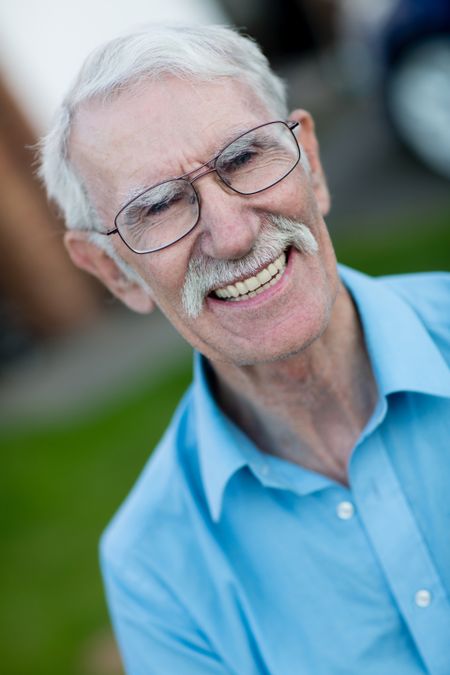 Portrait of a retired man smiling outdoors