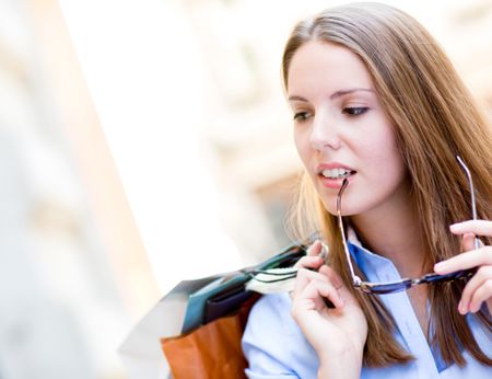 Beautiful young woman walking on the street shopping