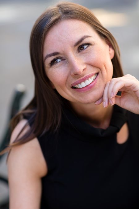 Thoughtful business woman looking up and smiling