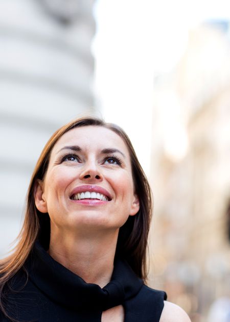 Portrait of a thoughtful businesswoman looking up outdoors