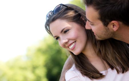 Affectionate young couple looking very happy at the park