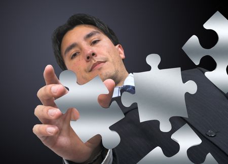 business man arranging puzzle pieces