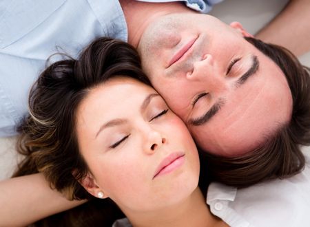 Beautiful couple sleeping with their heads together