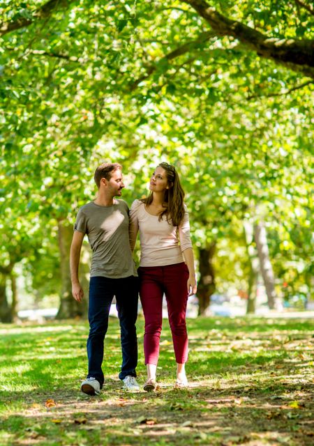 Romantic couple walking at the park looking happy