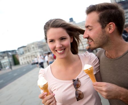 Romantic couple enjoying an ice cream outdoors