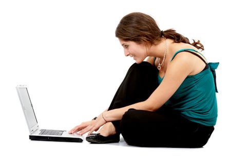woman working on a laptop computer on the floor isolated over a white background