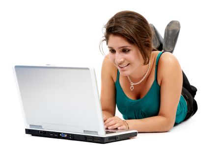 woman working on a laptop computer on the floor isolated over a white background