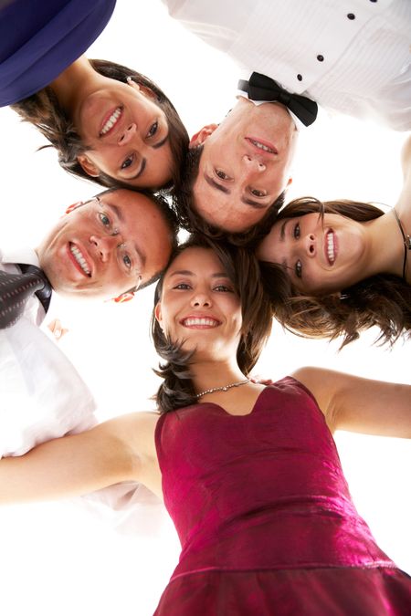 happy group of friends smiling with their heads together ready to party isolated over a white background