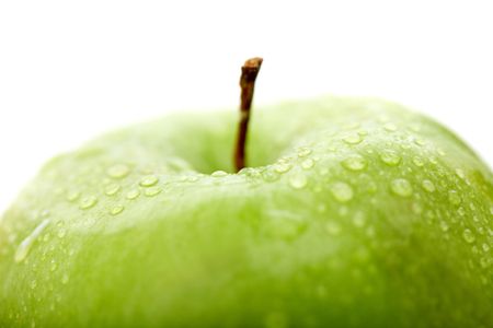 green apple close up with water drops isolated over a white background