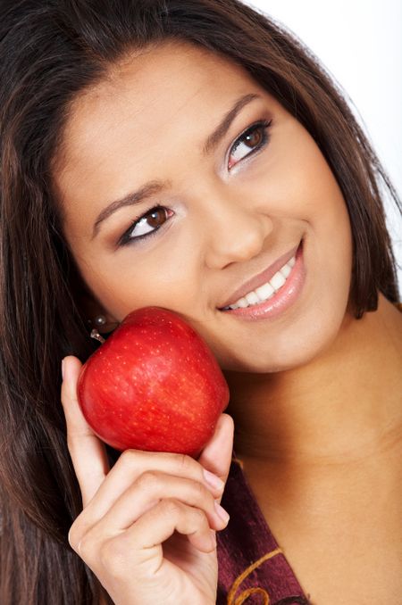 casual woman with an apple over a white background