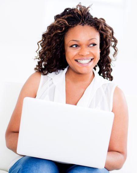 Happy woman with a computer at home and smiling
