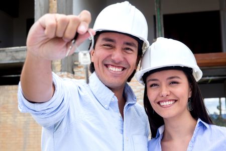 Couple buying a house under construction and holding the keys