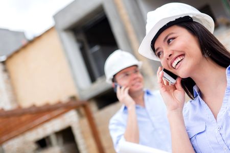 Engineers talking on the phone at a construction site