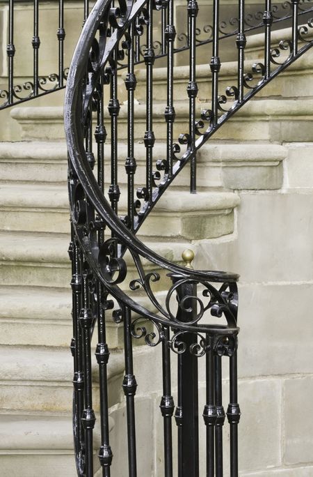 Vintage ironwork on winding staircase at front entrance to building