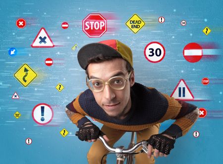 Young guy with stylish outlook and highway code on the background