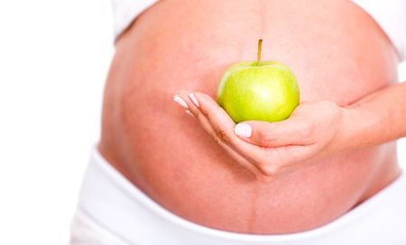 Pregnant woman eating healthy food - isolated over a white background