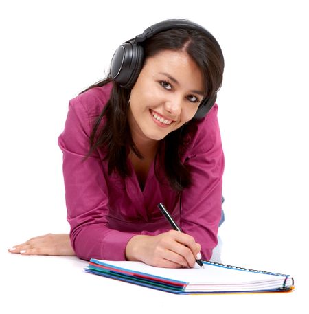 Casual student listening to music while studying isolated over a white background
