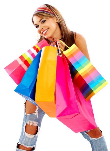 Casual woman smiling and carrying shopping bags isolated over a white background