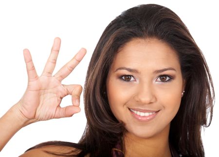casual woman smiling doing the ok sign isolated over a white background