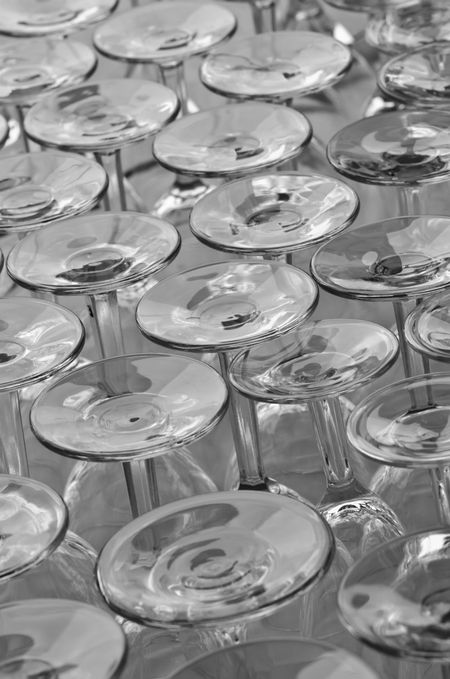 Restaurant repetition: Identical glasses for water upside down by window (black and white)