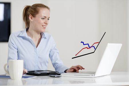 Young woman at her desk using her laptop, displaying a concept graph showing an increase