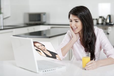Young woman at home doing online shopping, displaying a concept of a sales person.