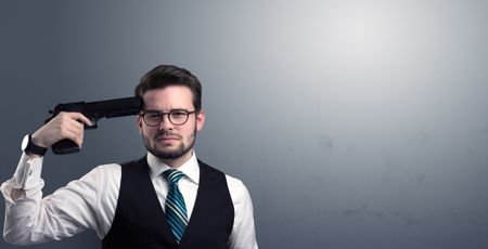 Young lost businessman man shooting his head with gun