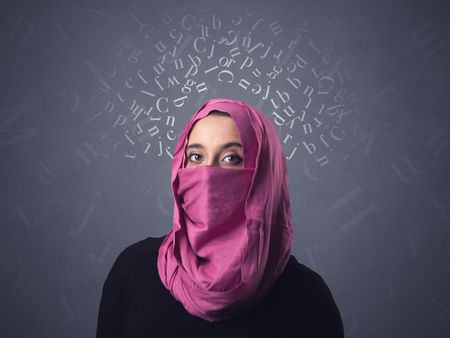 Young muslim woman wearing niqab with white alphabet letters above her head