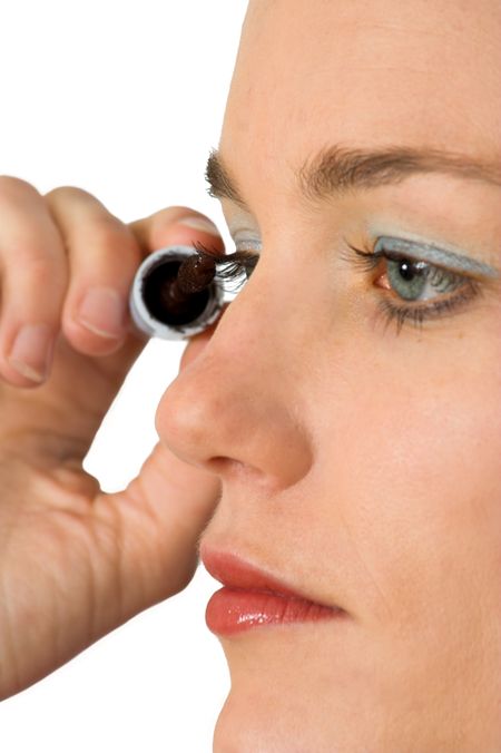 beautiful model applying mascara