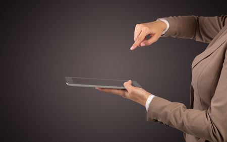 Female hand in suit holding tablet with no wallpaper