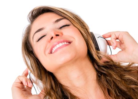 Woman listening to music with headphones - isolated over white