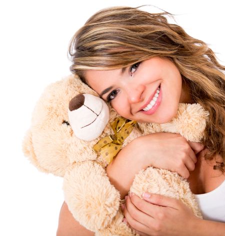 Cute woman holding a teddy bear - isolated over a white background