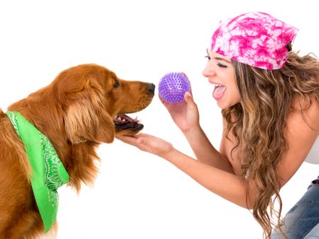 Woman playing with her dog throwing the ball - isolated over white