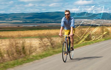 Young cyclist in casual clothing with fabulous nature background