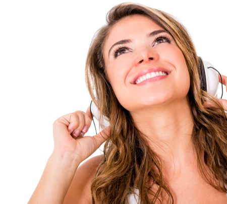 Woman listening to music with heaphones - isolated over a white background