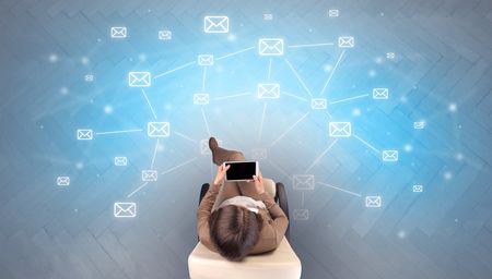 mail-symbols-woman-using-device-beige-1186511341 Mail symbols with woman using device in a beige chair