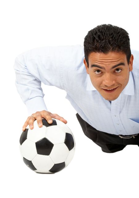 confident business man exercising on a  football isolated over a white background