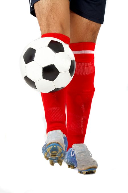 footballer legs playing with a ball isolated over a white background
