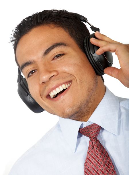 casual man listening to music in his headphones isolated over a white background