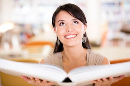 Woman with an open book at the library