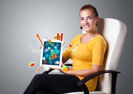 beautiful woman holding modern tablet with colorful diagrams and graphs