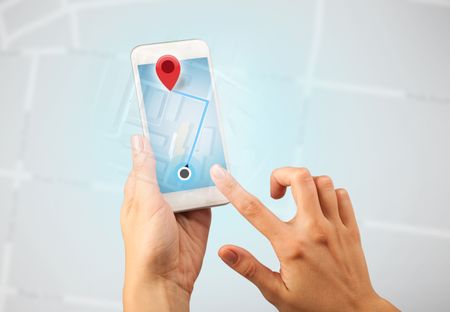 Female fingers touching smartphone with map
