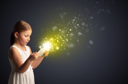 Little cute girl playing on sparkling tablet