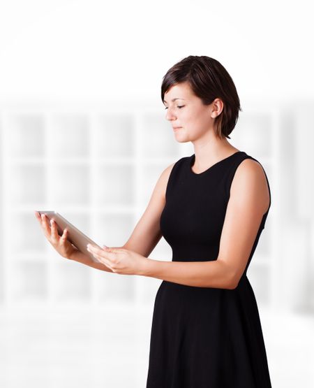 Young business woman looking at modern tablet