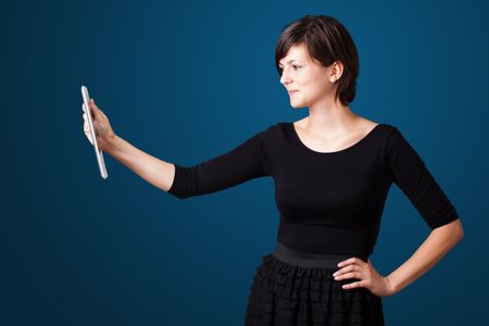 Young business woman looking at modern tablet